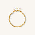 Close up of a gold rope chain bracelet on a white background