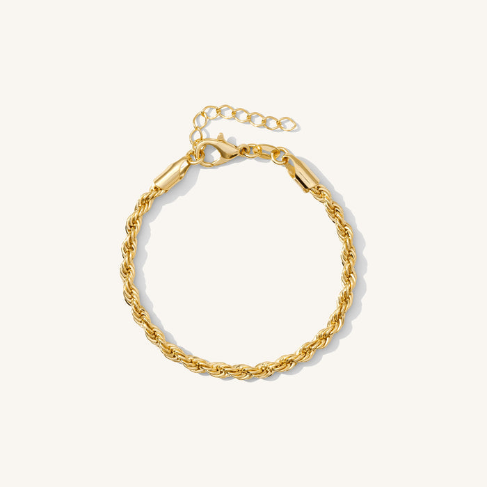 Close up of a gold rope chain bracelet on a white background