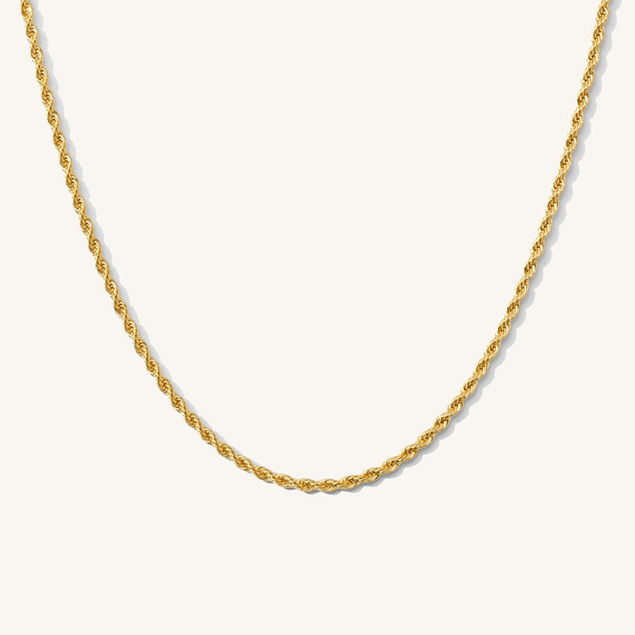 Close up of the gold Rio rope chain necklace on a white background