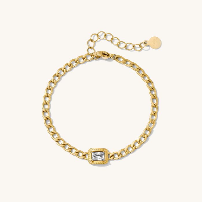 Close up of gold chain bracelet on a white background