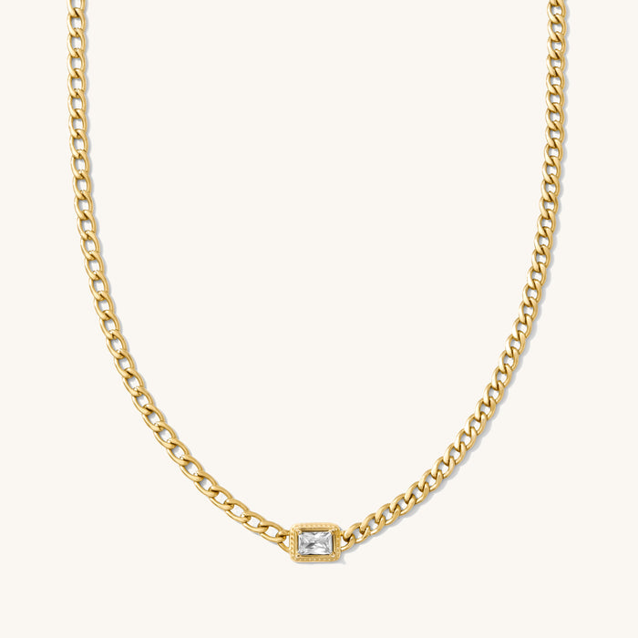 Close up of the gold Rocky cuban chain necklace on a white background