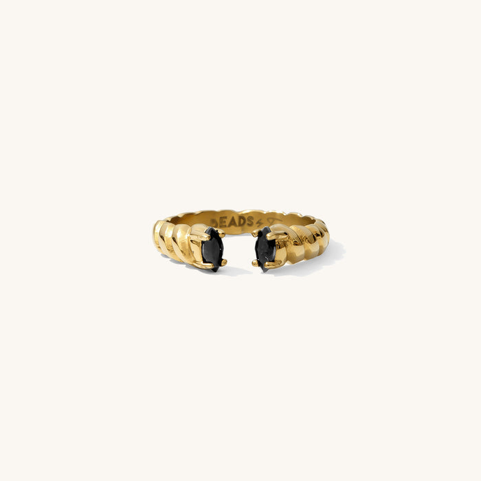 Roman ring in onyx, an open cuff band with black stones framing the opening
