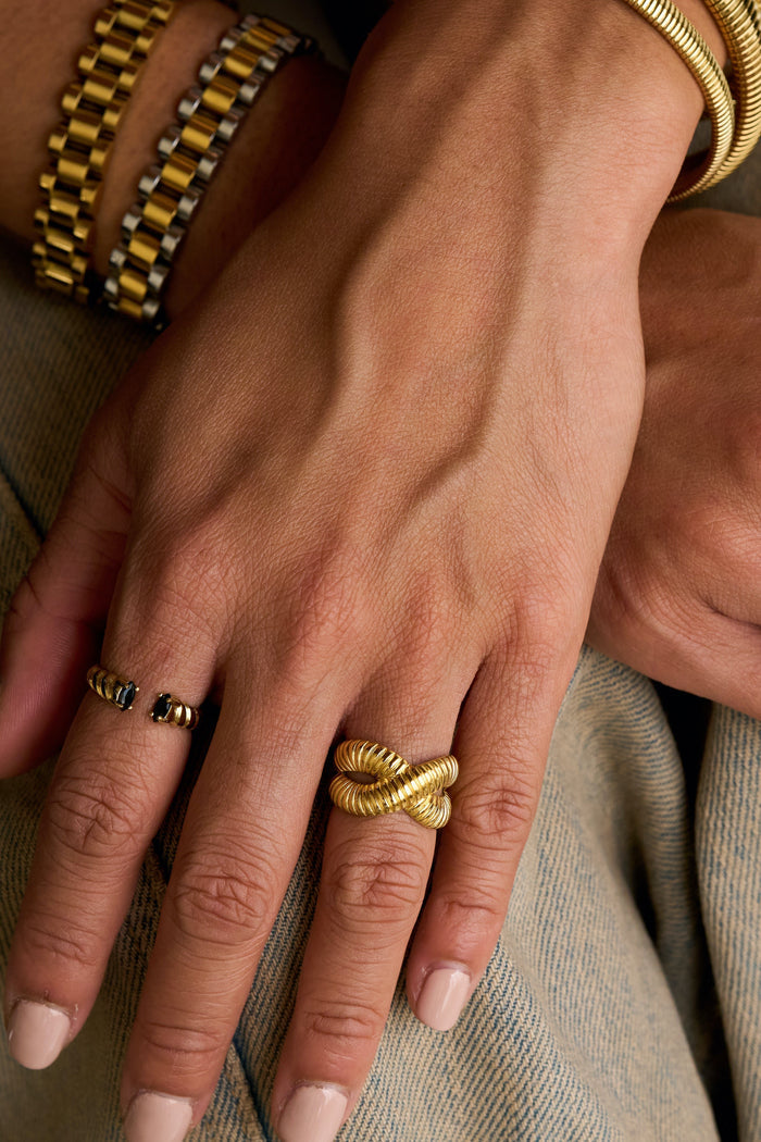 The Roman ring with black onyx accents wrapping around the finger