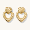 Close up of gold earrings on a white background