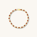 Bracelet with red and white stones on a white background