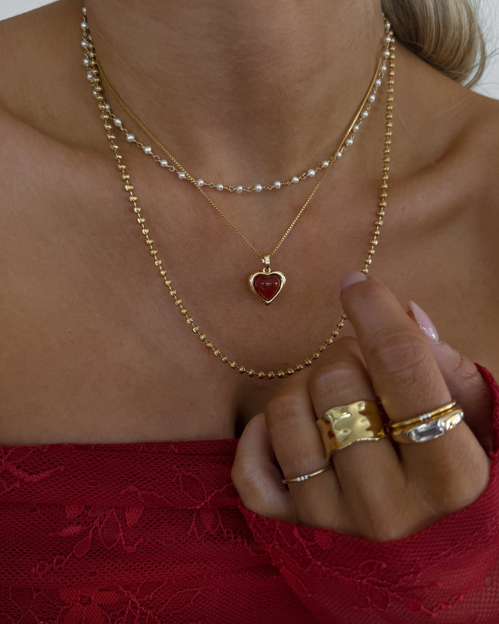 Model wearing the gold Sacred Heart necklace from Beads by Tara