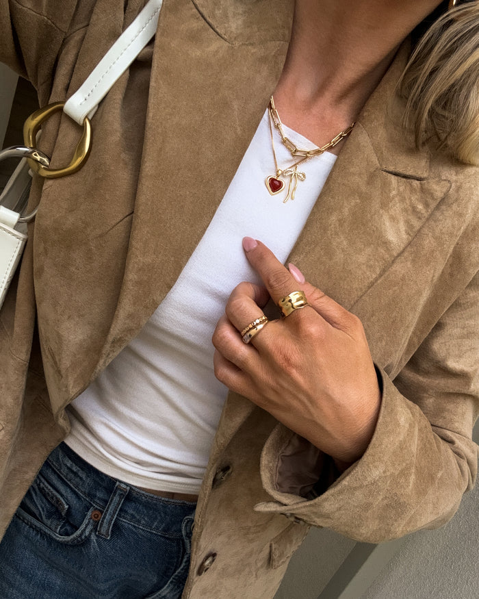 Campaign shot of a model wearing the gold Sacred Heart necklace