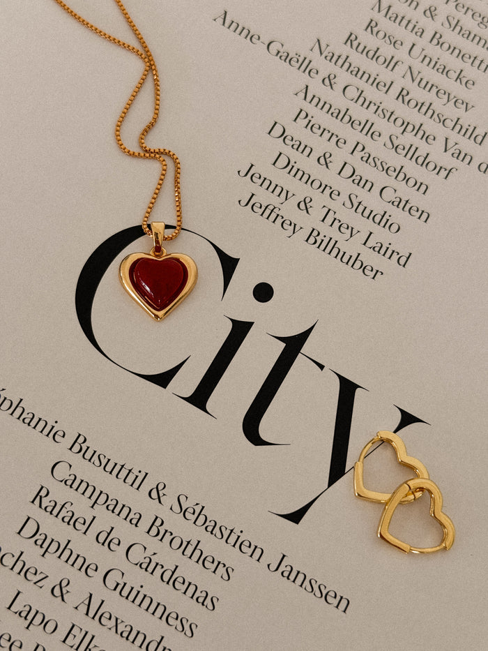 Campaign image of a model wearing the gold Sacred Heart necklace