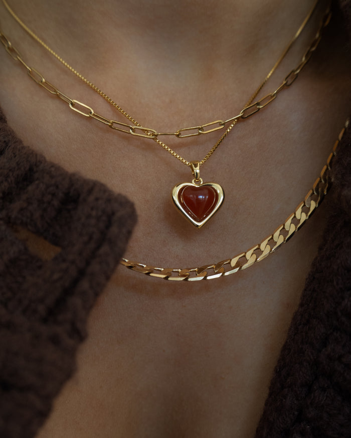 Model wearing the gold Sacred Heart necklace for Beads by Tara