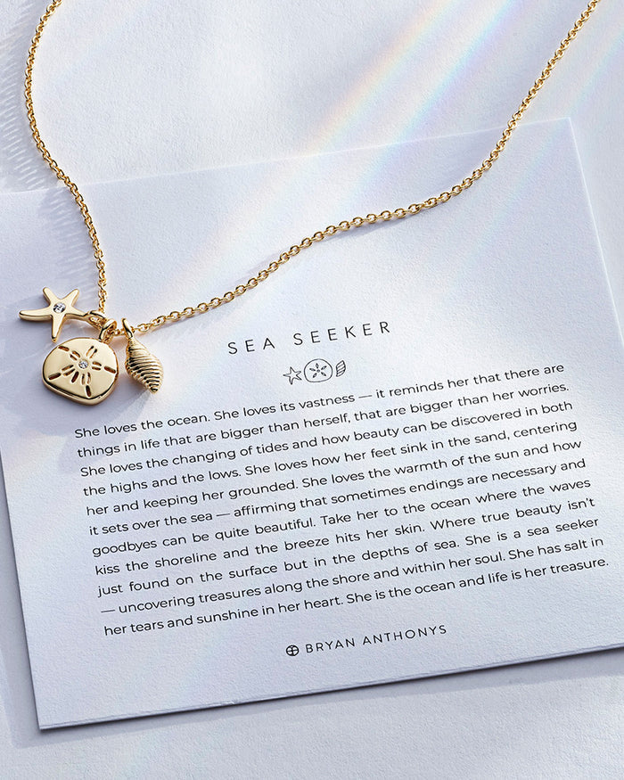 Sea Seeker Necklace showcase in 14k gold on card