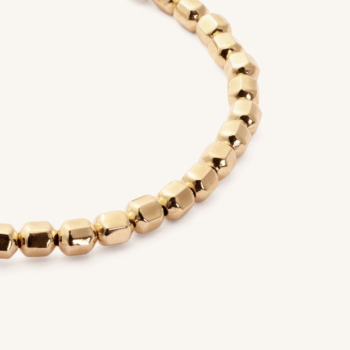 Close up of gold beads on a beaded bracelet