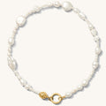 Close up of the gold Sirena baroque pearl necklace on a white background