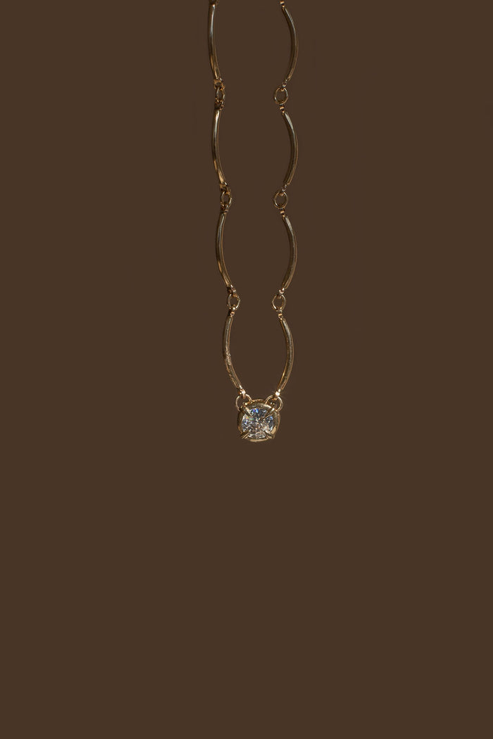 Solitaire Wave necklace in 14k gold fill with a single bezel set stone