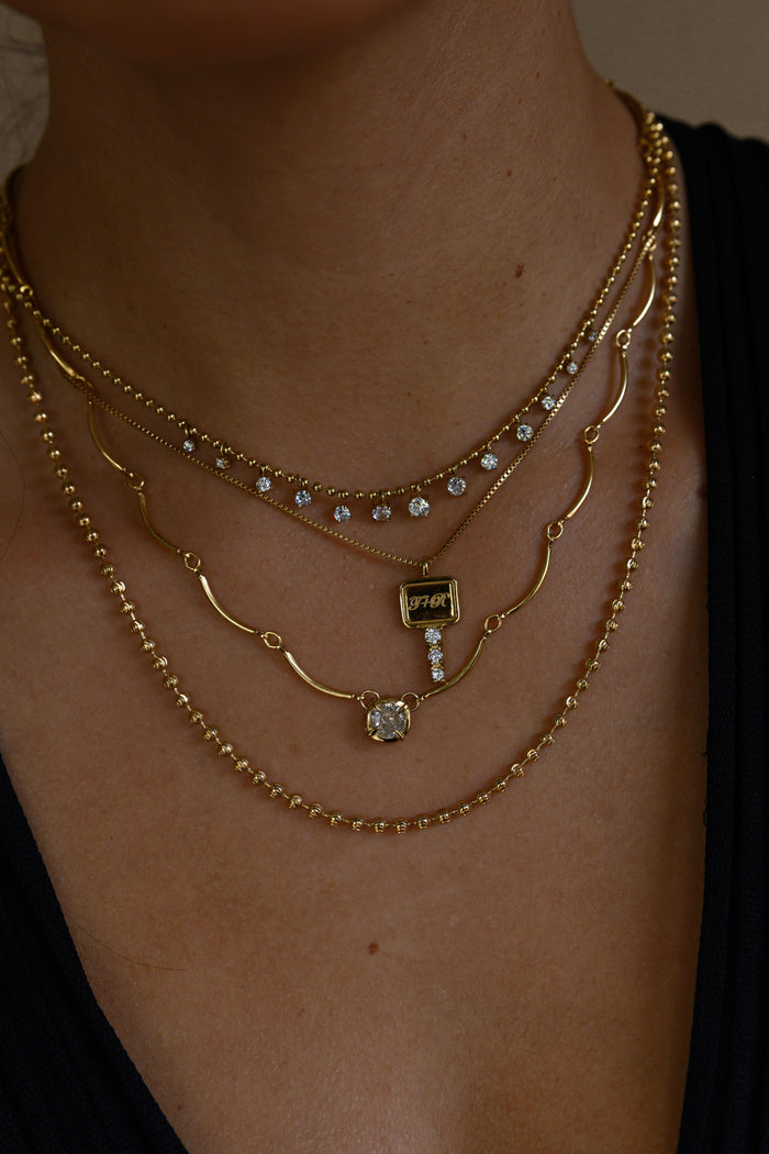 Fine gold necklaces with bezel set white topaz stones by Beads by Tara