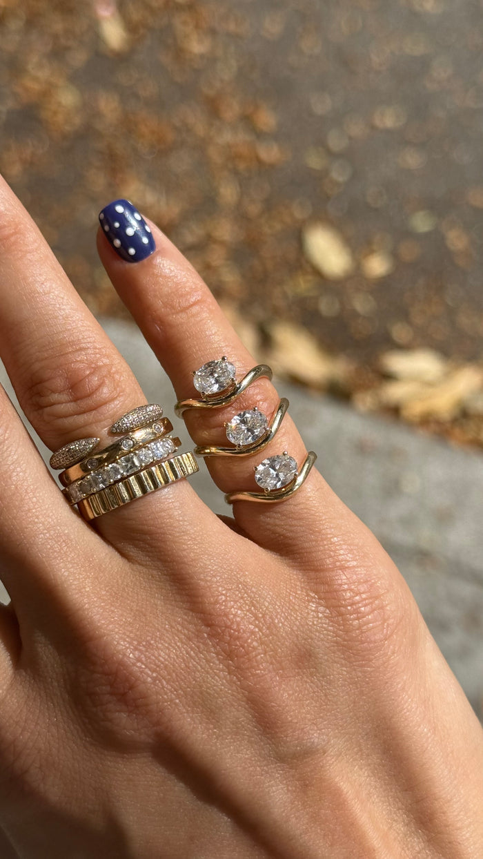 The Solitaire Wave pinky ring in 14k gold vermeil, set with a bright white topaz