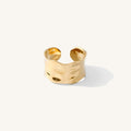The Solstice ring, a thin cuff-style band with a hammered gold finish