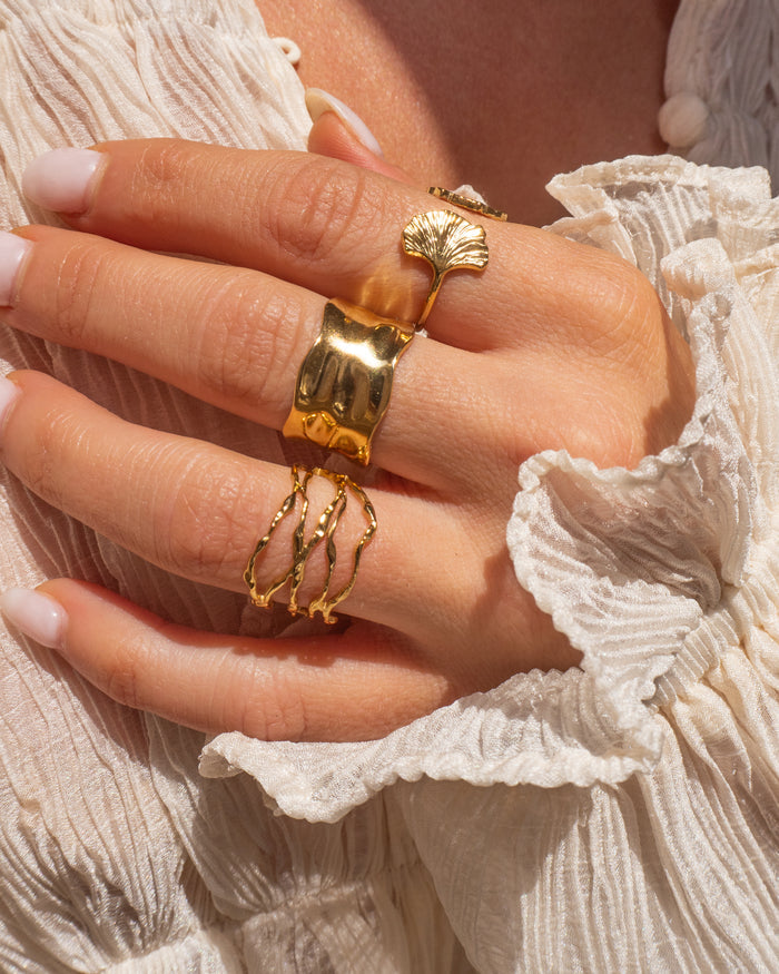 Model wearing the hammered gold Solstice cuff ring on the hand