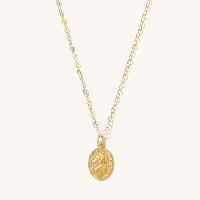 Gold St. Christopher pendant necklace on a dainty adjustable chain