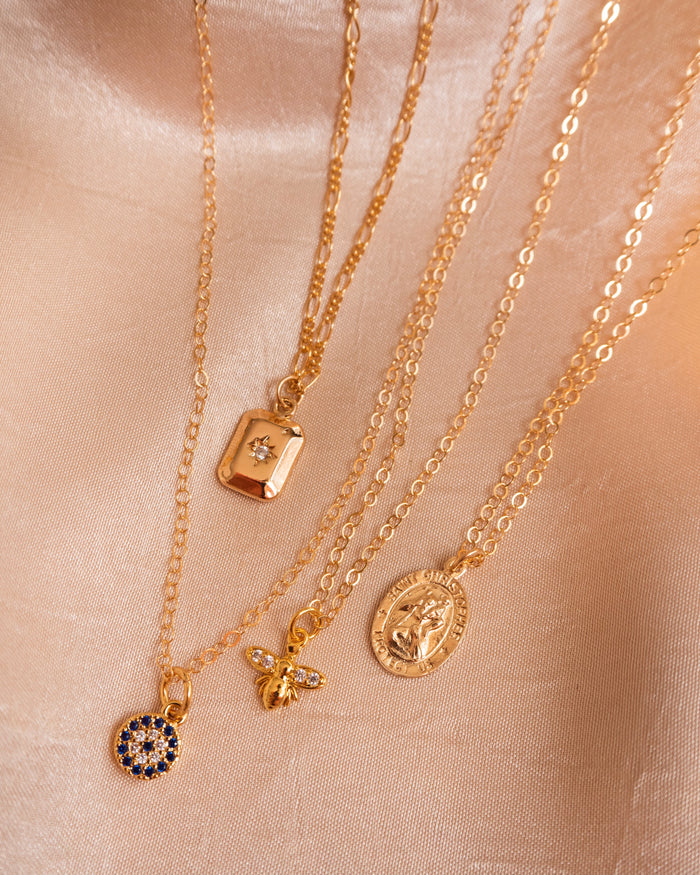 Gold St. Christopher necklace layered with the Starry Night and Evil Eye necklaces