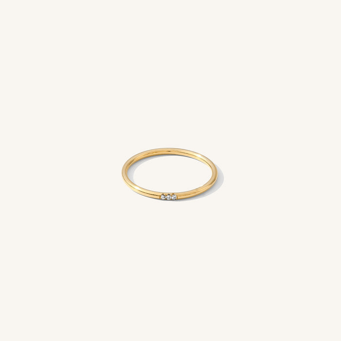 The Stardust ring with three petite stones set on a dainty gold band