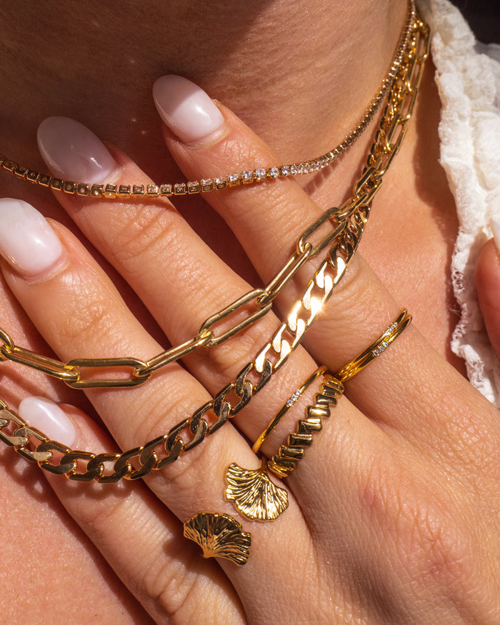 Model wearing the dainty gold Stardust ring stacked on the finger