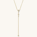 Close up of the Starlight lariat necklace with bezel-set stones on a white background