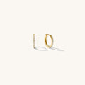 Close up of gold hoops with stones on a white background