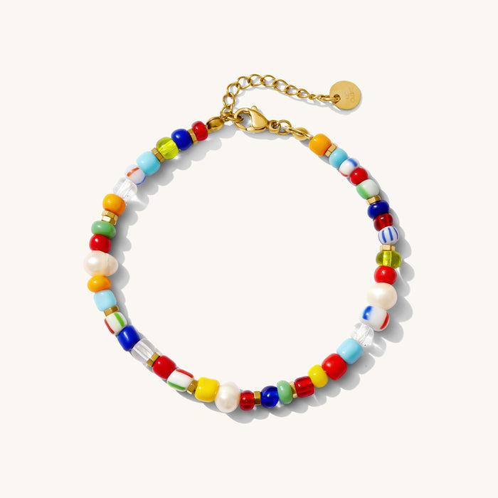 A colorful beaded gemstone bracelet with a gold-plated adjustable clasp, featuring multiple colors such as blue, red, yellow, and white.