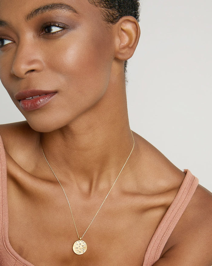 Model wearing Sun Moon & Stars Necklace in 14k gold finish