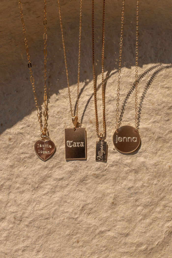The Sweetheart necklace heart charm glimmering on a fine dainty chain