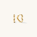 Close up shot of heart shaped hoop earrings on a white background