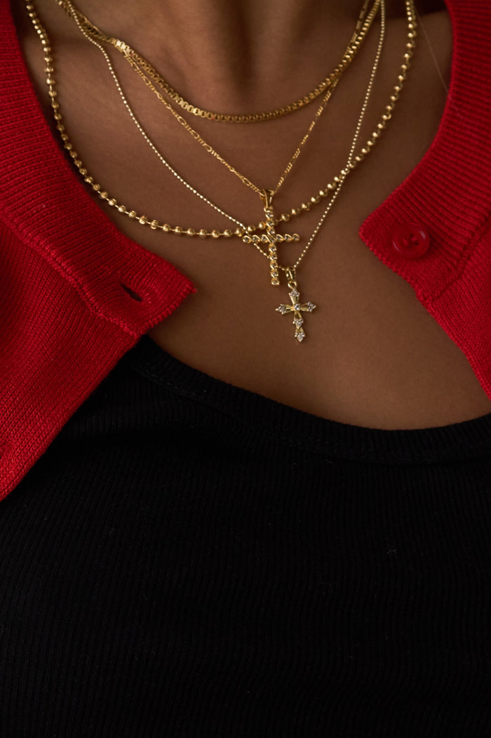 The Vintage Cross necklace showing the dimension of its sculpted pendant