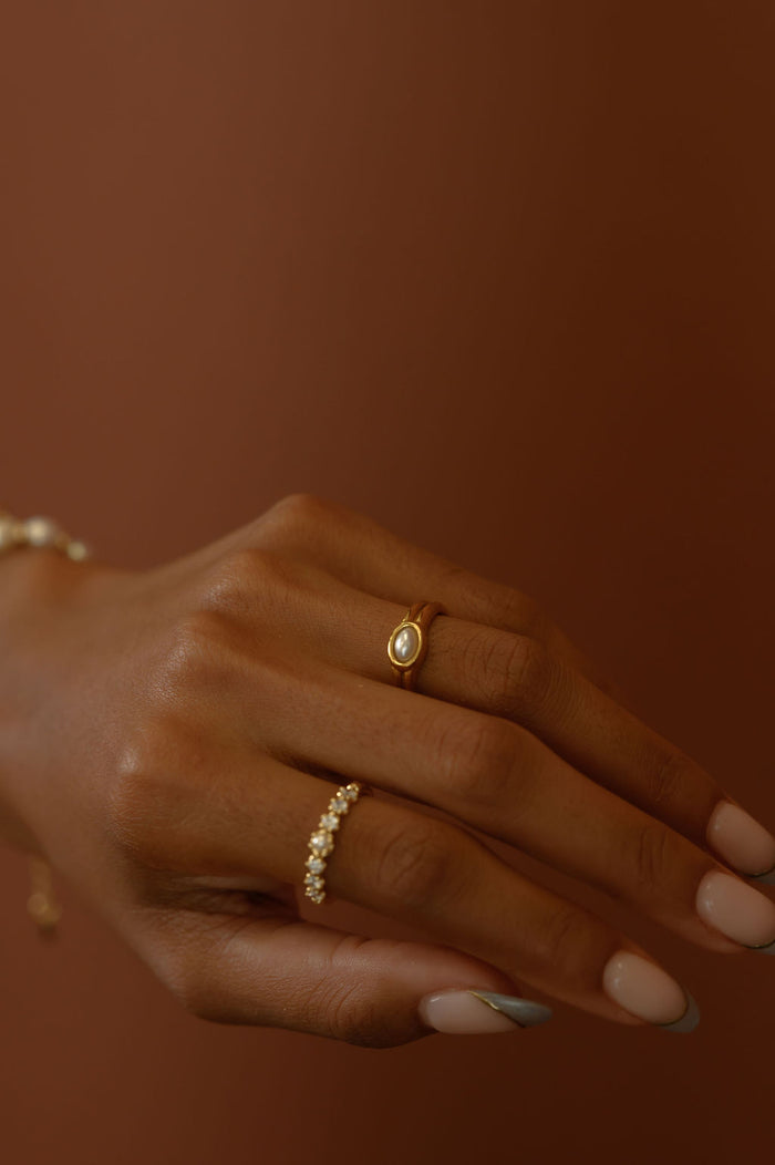 Detail view of the gold Vintage Pearl ring on a white background