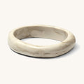 Close up of a warm white resin bracelet on a white background