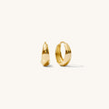 Close up of gold hoop earrings on a white background