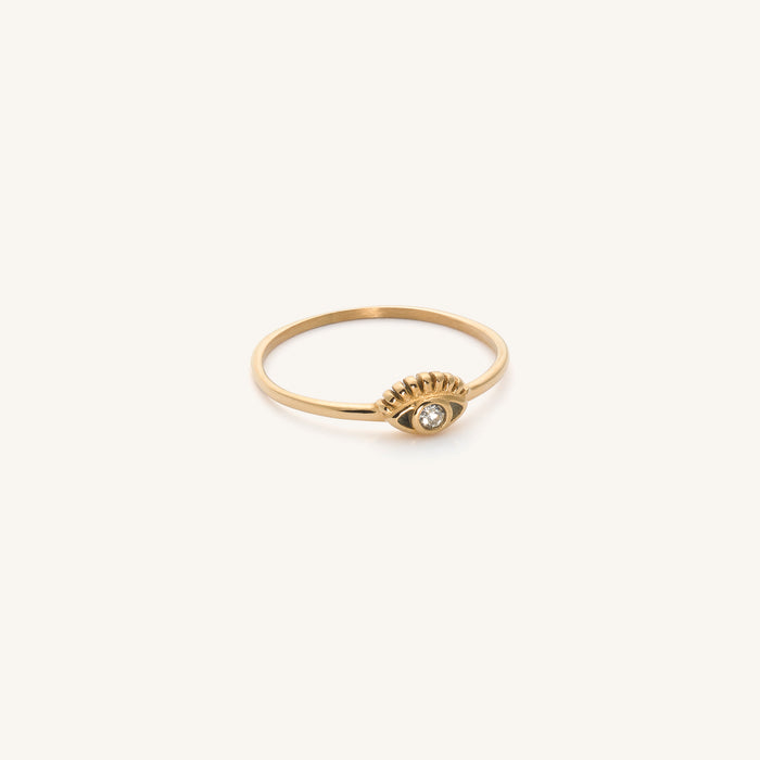 Close up of a hand wearing the gold Yaz evil eye ring with a CZ stone