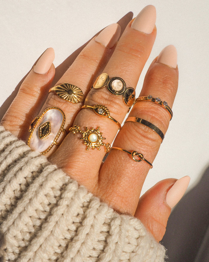 The gold vermeil Yaz eye ring worn stacked on a hand with other rings