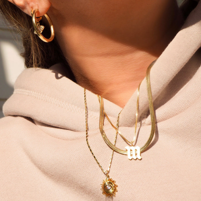 Close up of a neckline wearing the Yaz necklace with its evil eye pendant