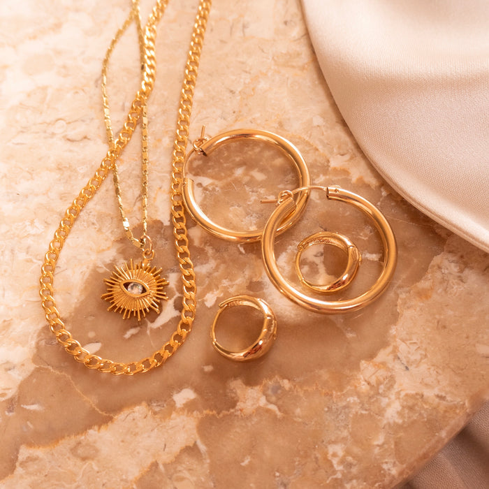 Gold Yaz evil eye necklace styled as an eye-catching everyday piece